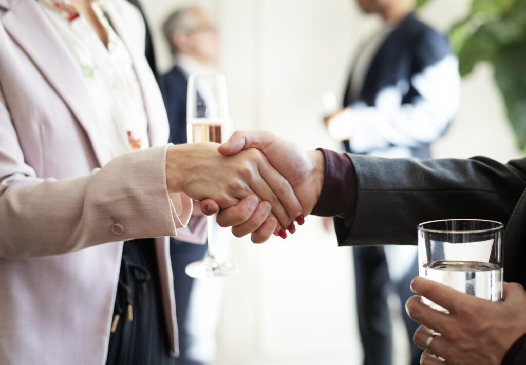 business people shaking hands at a networking event